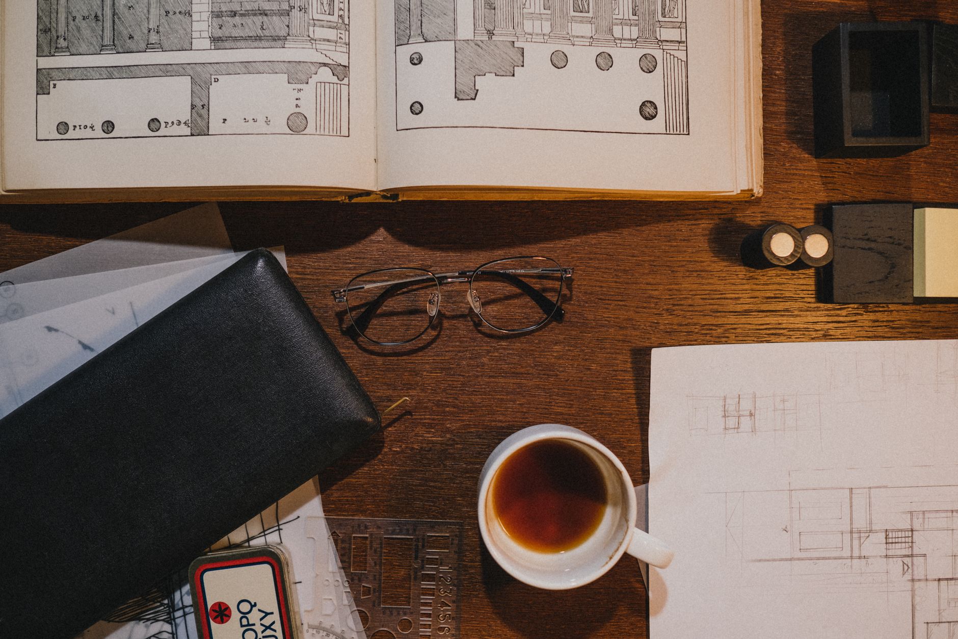 Desk with glasses, papers and a cup of tea