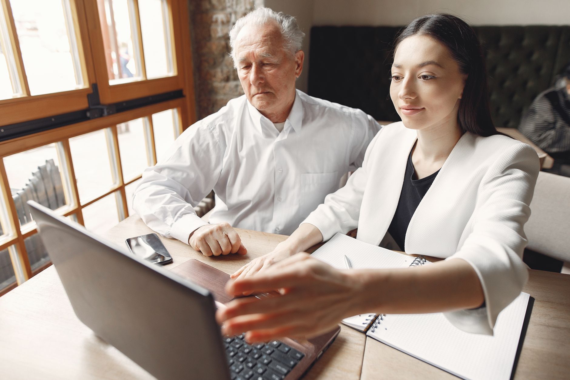 Two people looking at a laptop together