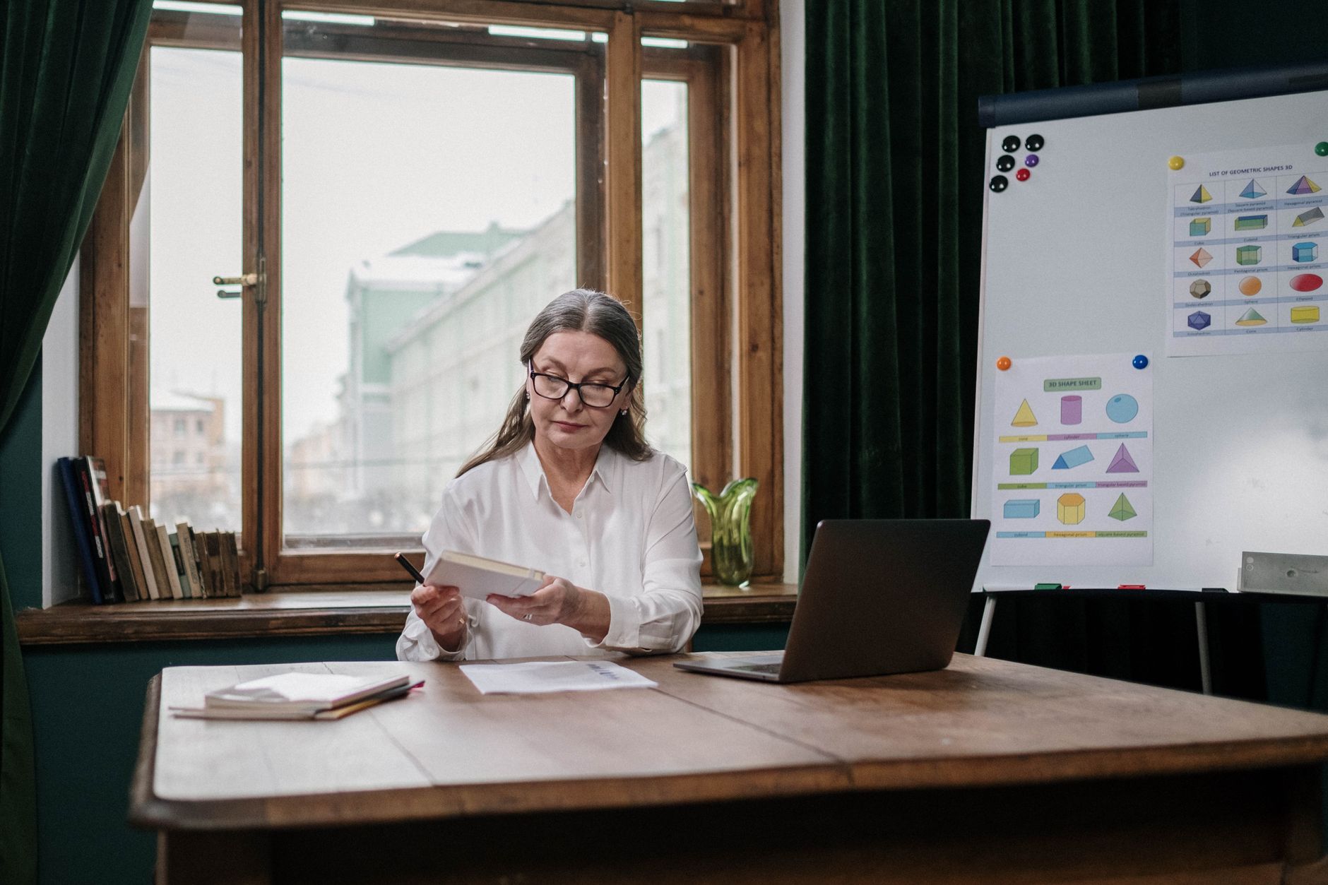 Person reading printed notes at a desk